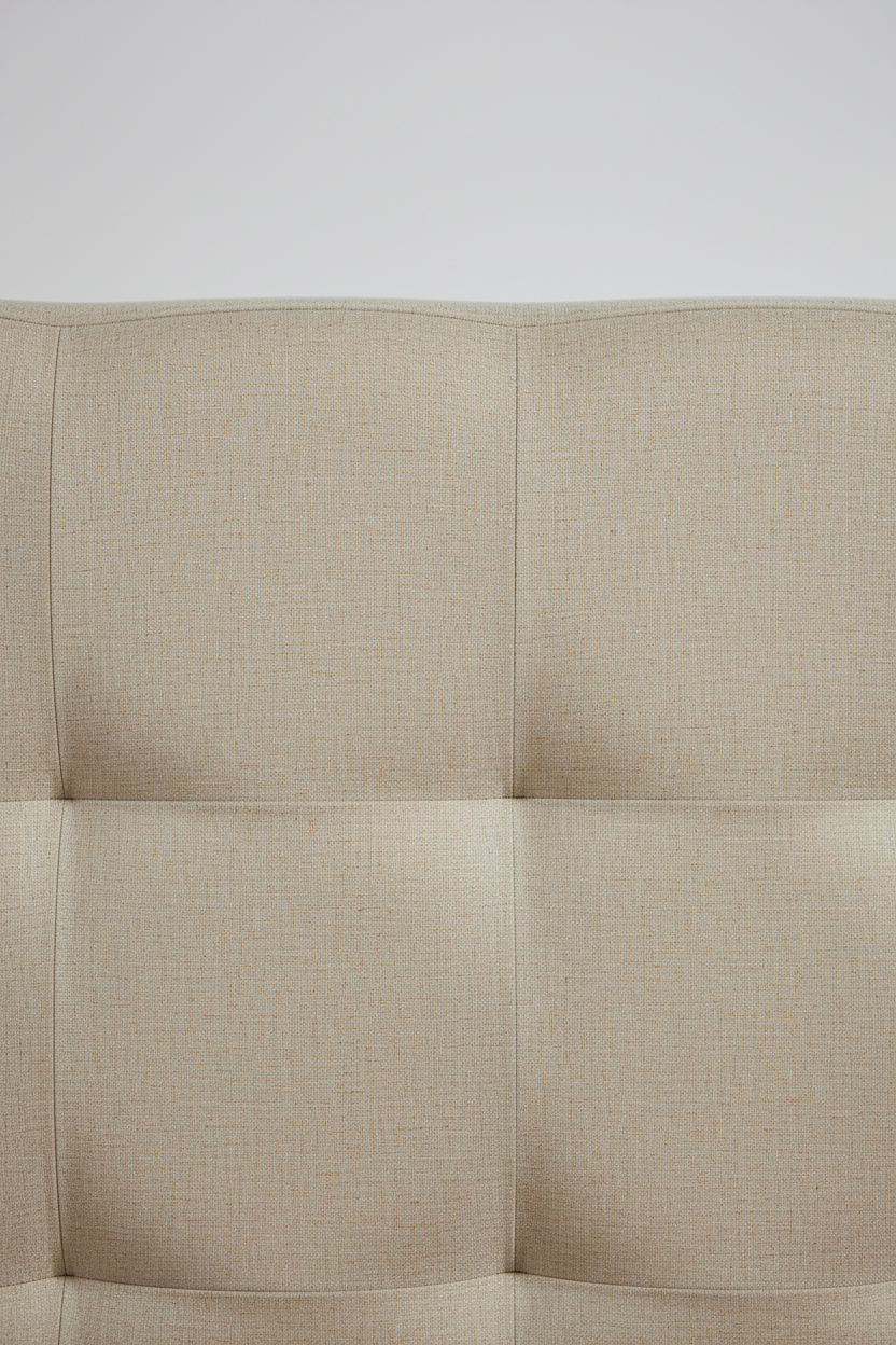 Close-up of premium beige linen upholstery and stitching on padded platform bed headboard